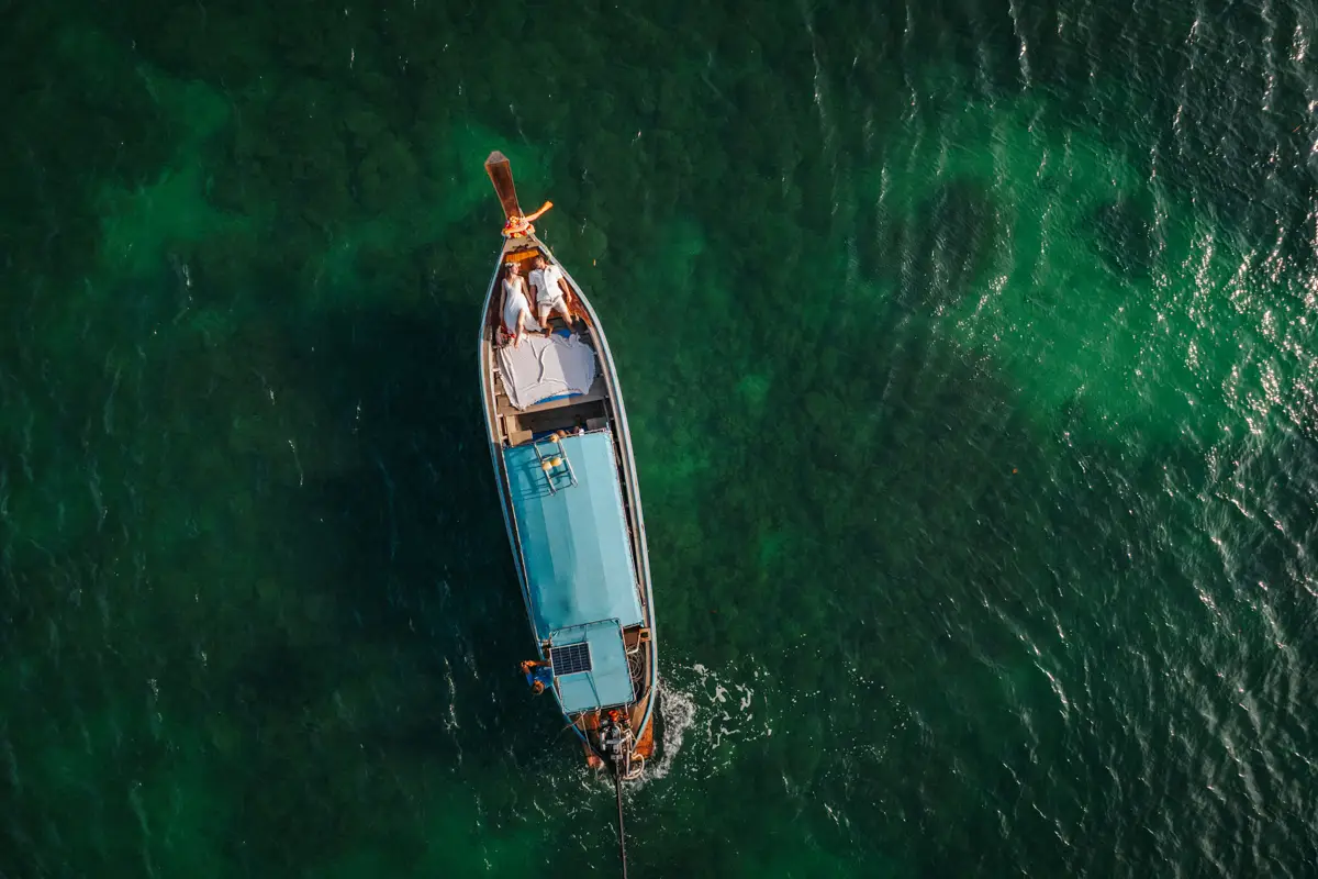 Rose and her fiancé's private wedding vows on a long-tail boat around Railay Beach , Krabi Thailand