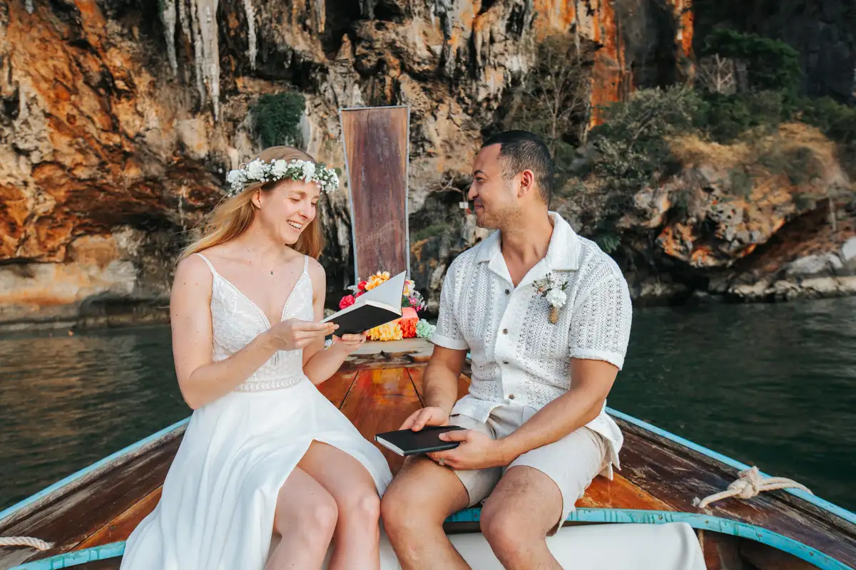 Rose and her fiancé's private wedding vows on a long-tail boat around Railay Beach , Krabi Thailand