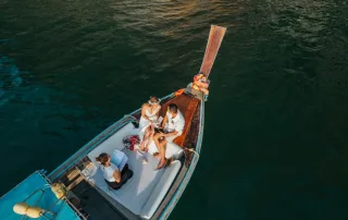Rose and her fiancé's private wedding vows on a long-tail boat around Railay Beach , Krabi Thailand