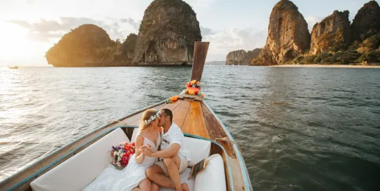 Rose and her fiancé's private wedding vows on a long-tail boat around Railay Beach , Krabi Thailand